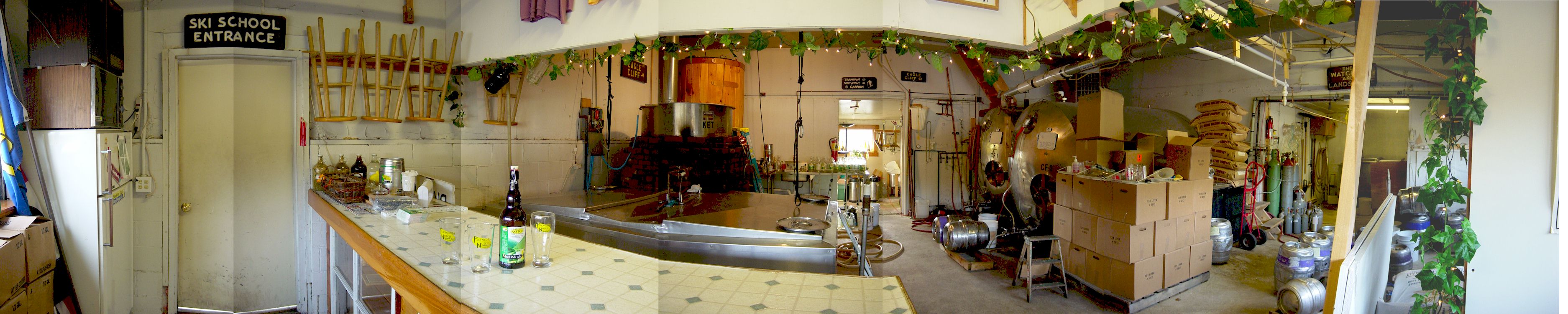 360-degree panoramic view inside Franconia Notch Brewing Company — bar, brew kettle, fermentation equipment, and hop vines